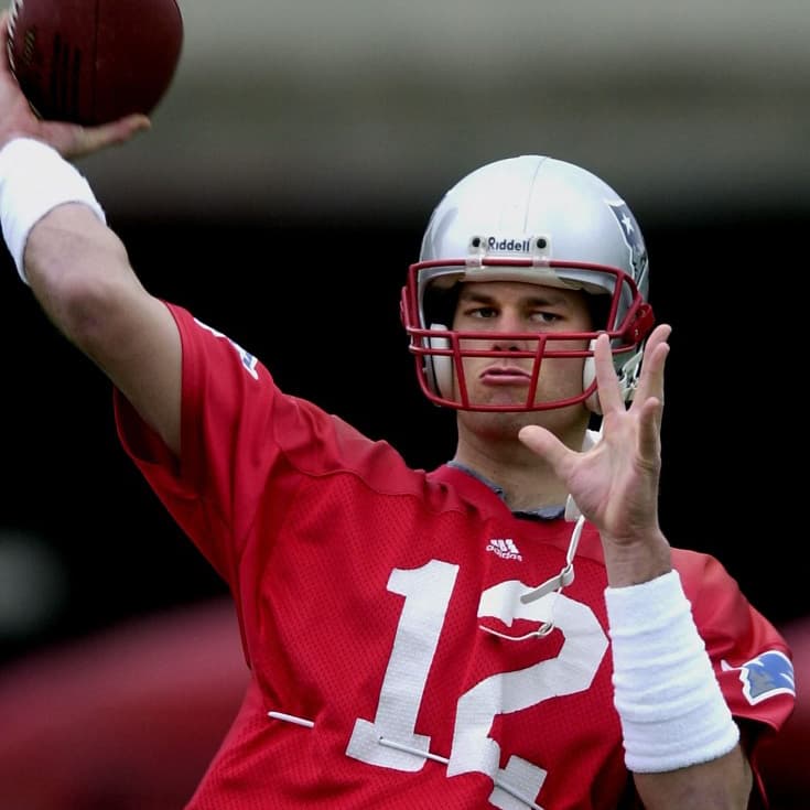 New England Patriots quarterback Tom Brady throws a football during his team's practice  01 February 2002 in New Orleans, LA. The New England Patriots will play the Saint Louis Rams in Super Bowl XXXVI 03 Febuary 2002.     AFP PHOTO/Roberto SCHMIDT (Photo by Roberto SCHMIDT / AFP)