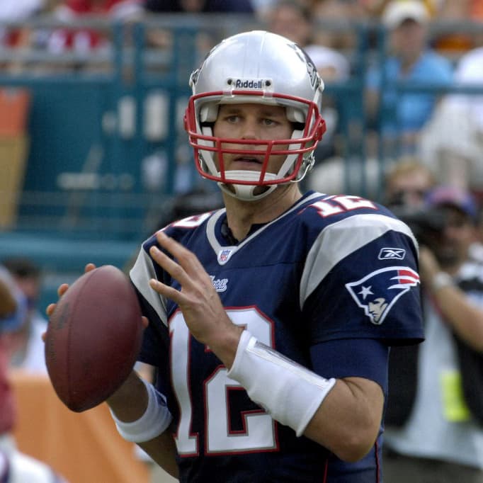 MIAMI, FL - OCTOBER 21: Quarterback Tom Brady #12 of the New England Patriots sets to pass against the Miami Dolphins at Dolphin Stadium on October 21, 2007 in Miami, Florida.  The Pats won 49 - 28. (Photo by Al Messerschmidt/Getty Images) (Photo by Al Messerschmidt / Getty Images North America / Getty Images via AFP)