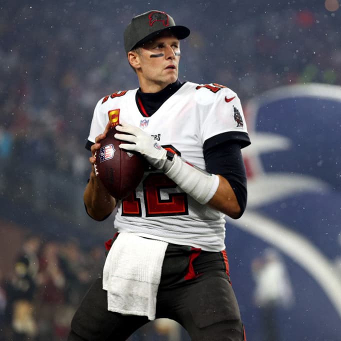 FOXBOROUGH, MASSACHUSETTS - OCTOBER 03: Tom Brady #12 of the Tampa Bay Buccaneers warms up in front of the New England Patriots tunnel before the game between the Buccaneers and the Patriots at Gillette Stadium on October 03, 2021 in Foxborough, Massachusetts.   Maddie Meyer/Getty Images/AFP (Photo by Maddie Meyer / GETTY IMAGES NORTH AMERICA / Getty Images via AFP)