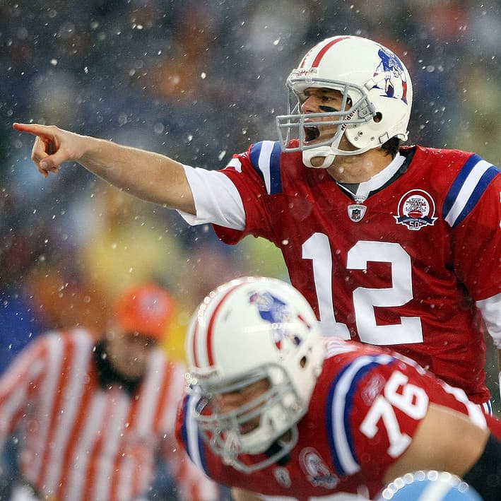 FOXBORO, MA - OCTOBER 18:  Quarterback Tom Brady #12 of the New England Patriots calls out the play as Sebastian Vollmer #76 listens in the first quarter against the Tennessee Titans on October 18, 2009 at Gillette Stadium in Foxboro, Massachusetts.  (Photo by Elsa/Getty Images)