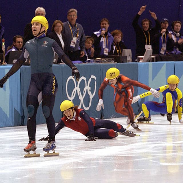16 Feb 2002:  Australia's first ever Winter Gold medal winner Steven Bradbury crosses the line while America's Apolo Anton Ohno scrambles for the line to claim second place after the men's 1000m speed skating final during the Salt Lake City Winter Olympic Games at the Salt Lake Ice Center in Salt Lake City, Utah. DIGITAL IMAGE.  Mandatory Credit: Steve Munday/Getty Images