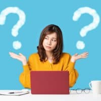 Young woman comparing with two things.