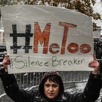 NEW YORK, NY - DECEMBER 09: People carry signs addressing the issue of sexual harassment at a #MeToo rally outside of Trump International Hotel on December 9, 2017 in New York City. (Photo by Stephanie Keith/Getty Images)
