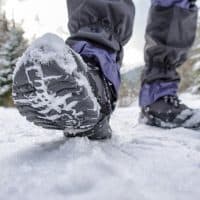 Black hiking boots walking outside in the snow