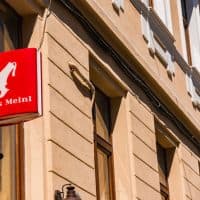 Cluj-Napoca, Romania - JUN 20, 2021: Julius Meinl logo banner hanging in the exterior of an old European building