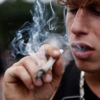 BERLIN, GERMANY - AUGUST 13: An participant smokes as activists demonstrating for the legalisation of marijuana march in the annual Hemp Parade (Hanfparade) on August 13, 2022 in Berlin, Germany. So far owning, cultivating and selling cannabis in Germany is still illegal, though the current coalition government campaigned on cannabis legalisation and is scheduled to begin debating corresponding legislation in coming months. (Photo by Carsten Koall/Getty Images)