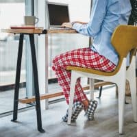 Cropped shot of a woman using a laptop while working from home