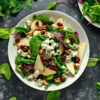 Fresh Pears, Blue Cheese salad with vegetable green mix, walnuts, cranberry. healthy food.