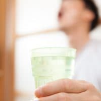 man gargling his throat