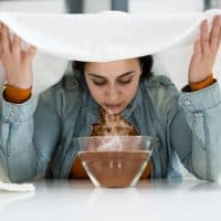 Woman Doing Inhalation Alternative Herbal Medicine Using Steam Bowl