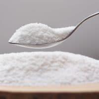 Put natural sweetener stevia from a pile into a spoon