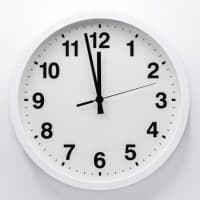 Simple analog wall clock on white background.