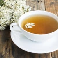 Yarrow Tea, Achillea Millefolium , on a Rustic Wooden Background.