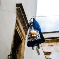 Typical Epiphany scene in Italy with a Befana hanging on a cable