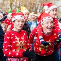 People take part in an Ugly Christmas Sweater Run on December 16, 2017 in The Vondelpark in Amsterdam, Netherland. During this 5K run, people have the chance to show pride in their ugly sweater as their sweat it out at the national Ugly Sweater Run at the Vondelpark, in Amsterdam. The event allows those who take part the chance to run, walk or jingle into the holiday spirit with friends, family, kids and dogs. Ugly sweater run is also celebrated in other countries, like in the USA, making of this, a Christmas tradition. A portion of the proceeds was donated to Save the Children charity. (Photo by Romy Arroyo Fernandez/NurPhoto via Getty Images)