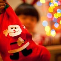 Christmas sock holding by little boy.