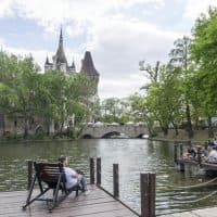 Budapest, Hungary - April 26, 2016: People enjoy their free time at Városliget, a beautiful city park in the heart of the city, in the foreground part of the lake surrounding the castle.
