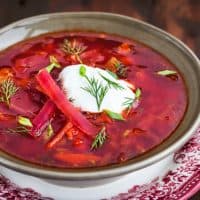 Ukrainian ore russian national red borscht (beet soup) with sour cream and herbs