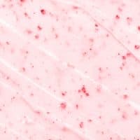 Strawberry ice cream texture close up. Top view. Pink fruit ice cream background with small pieces of berries