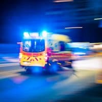 The ambulance circulating the streets at night, close-up, long exposure