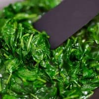 Baby spinach cooked in the pan until softened