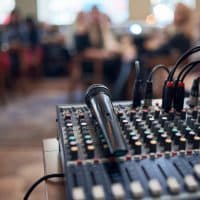 Microphone voice speaker on audio mixer machine in conference hall, seminar event or wedding ceremony party.