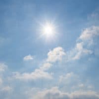 The sun shines brightly in the blue sky