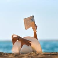 heat-temperature,idyllic,sun hat,sunbathing,straw, hat,sunny,beach holiday,climate,lying down,lying on back,literature,20-29 years,30-39 years,reflection,sensuality,color photo,multicolor,cheerful,twilight,color photo,human body,hand,carefree
