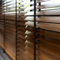 wooden window shutter blind with light from sun home interior concept