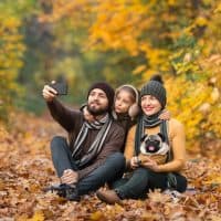 holidays, vacation, travel and tourism concept - group of friends or couples having fun in autumn park and taking selfie