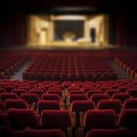 Empty red armchairs of a theater ready for a show