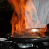 Flames while Chef cooking a table side flambé.