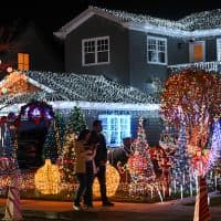 SAN CARLOS, CA - DECEMBER 04: People visit Eucalyptus Ave to see Christmas decorations and lights of houses in San Carlos, California, United States on December 04, 2023. (Photo by Tayfun Coskun/Anadolu via Getty Images)