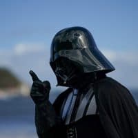 SCARBOROUGH, ENGLAND - APRIL 09: A man dressed as the Star Wars character Darth Vader reacts on the first day of the Scarborough Sci-Fi weekend at the seafront Spa Complex on April 09, 2022 in Scarborough, England. The North Yorkshire seaside town of Scarborough hosts the event that showcases many areas of Sci-Fi fandom to entertain visitors and enthusiasts including guest star appearances, panel discussions, gaming, cosplay, props, comic books and merchandise stalls with many of those attending wearing costumes and outfits of their favourite Sci-Fi characters. (Photo by Ian Forsyth/Getty Images)