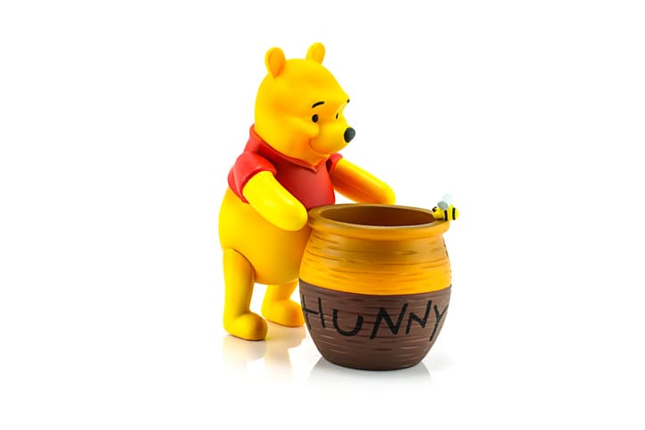 Bangkok, Thailand - July 28, 2014 : Figure of Winnie the Pooh and hunny pot. Winine the Pooh is animation from Disney.