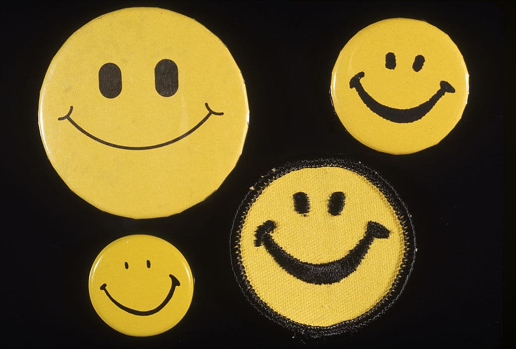 View of four differently styled (and sized) Smiley face buttons, 1970s. (Photo by Blank Archives/Getty Images)