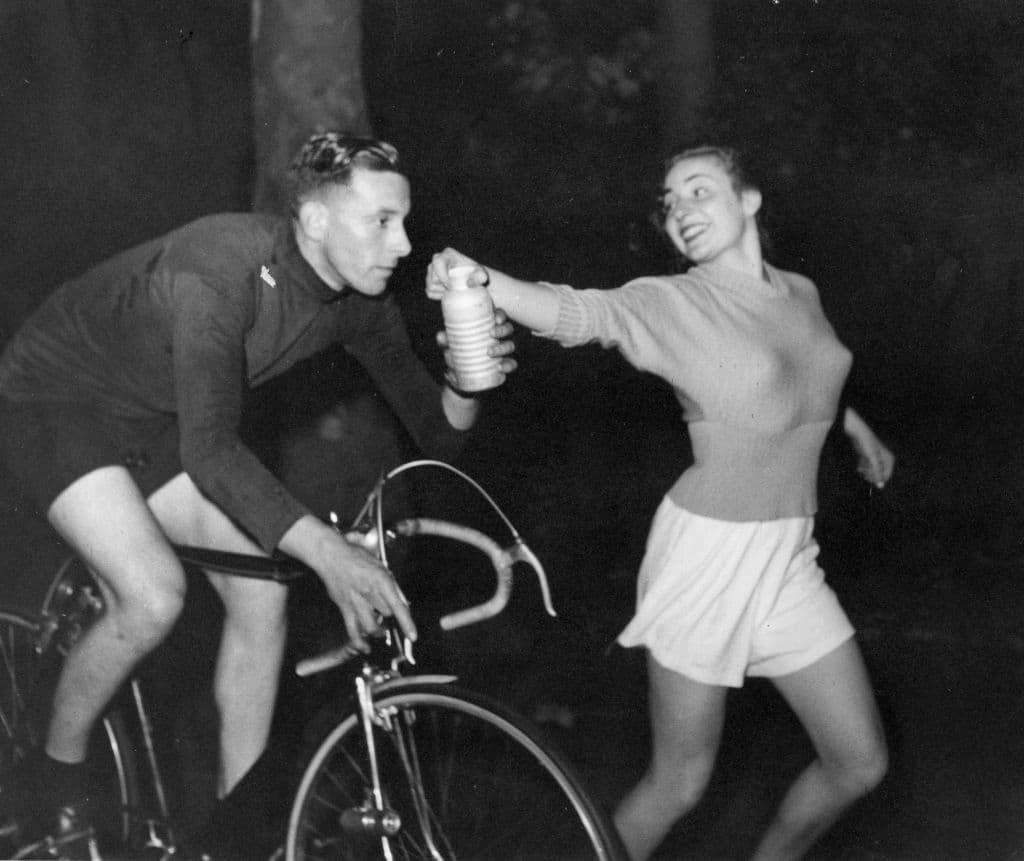 Ken Joy receives a 'bidon', an aluminium can containing milk and sugar to restore his energy levels during his successful bid to break the London to Brighton cycling speed record.  Original Publication: Picture Post - 4912 - The Record Is Smashed - pub. 1949   (Photo by Bert Hardy/Getty Images)
