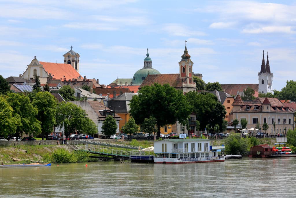 (GERMANY OUT)   Hungary, Central Hungary, Pest County, Vac, Danube, Danube promenade, jetty, boat, f.l.t.r. parish church in the upper town, cupola of the cathedral, Greek Orthodox church, Piarists church   (Photo by Werner OTTOullstein bild via Getty Images)