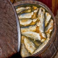 Surströmming is fermented fish, the best way to eat it is on buttered crispbread with cheese, with the fish mashed up with boiled potatoes. Because of the strong smell, surströmming is ordinarily eaten outdoors. The pressurized can is usually opened some distance away from the dining table.