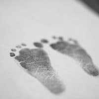 Baby footprints inked on paper