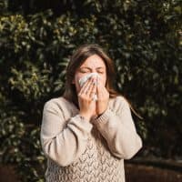 adult woman in the nature suffering allergy
