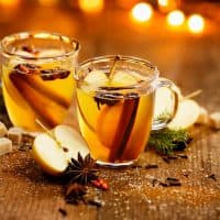 Hot cider with addition of cinnamon sticks, anise stars, cloves and citrus fruits