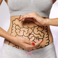 women cradling her internal organs / intestines