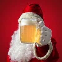 Santa Claus with a mug of beer. Coloured background and seletive focus.