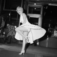 Film star Marilyn Monroe poses over a Manhattan subway grate as the wind blows her white dress up. Photographers capture the moment on camera, which takes place on September 16, 1954, during the filming of Seven Year Itch. Reportedly, Monroe's husband Joe DiMaggio was displeased at the attention his wife received from the crowds.